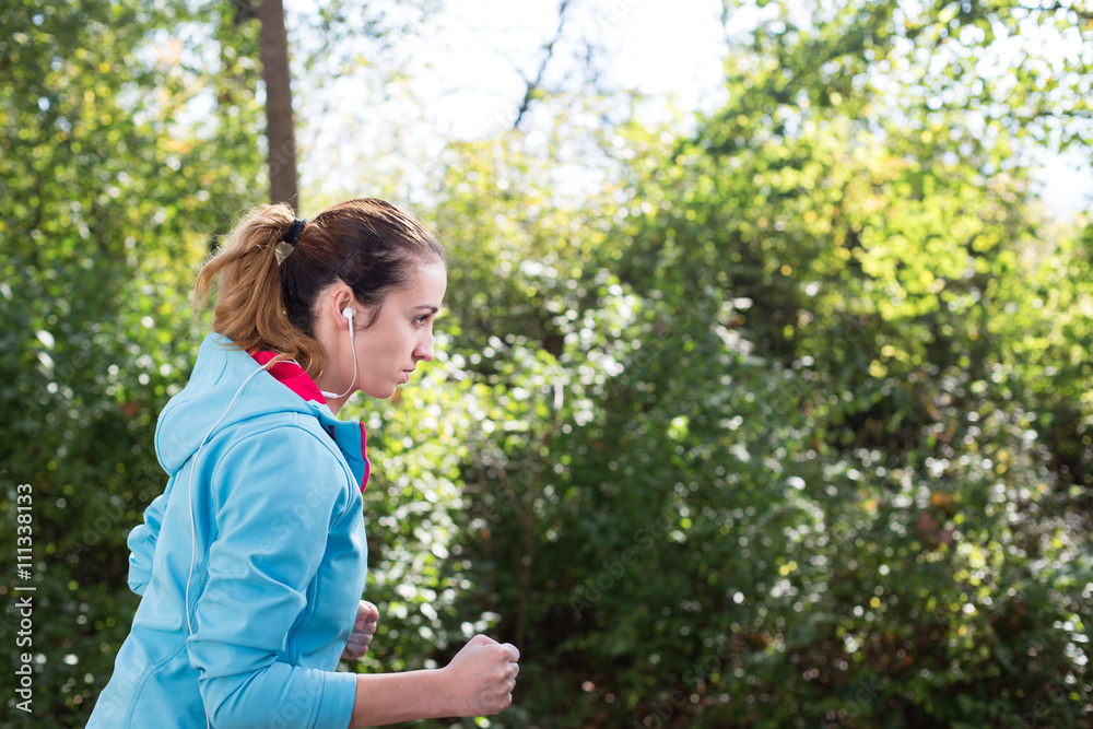 jogging running female straight in park with sun jogging running female straight in park with sun