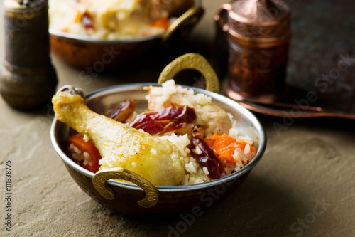 pilaf with chicken and pumpkin in a copper bowl