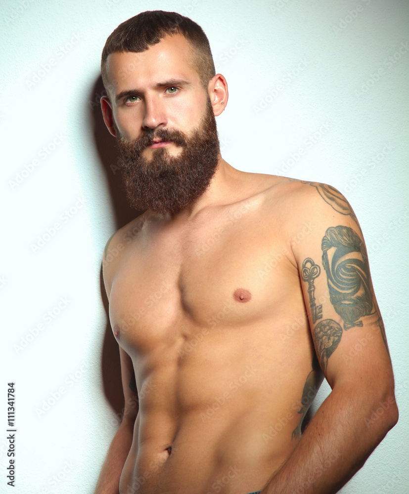 Fototapeta premium Portrait of handsome bearded man standing, isolated on grey bac