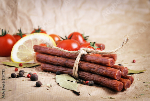 Beef sticks, sausages on a paper background