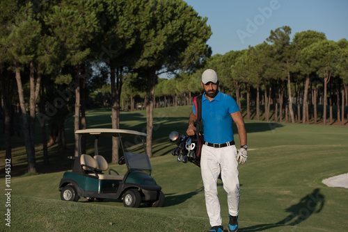 golfer walking and carrying golf bag