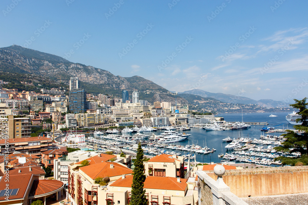 Monte Carlo harbor with luxury yachts and the city skyline 