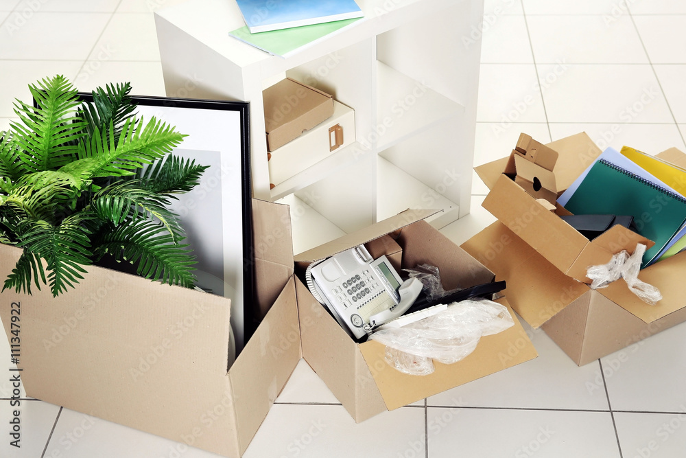 Move concept. Unpacking cardboard boxes in a new office Stock Photo ...