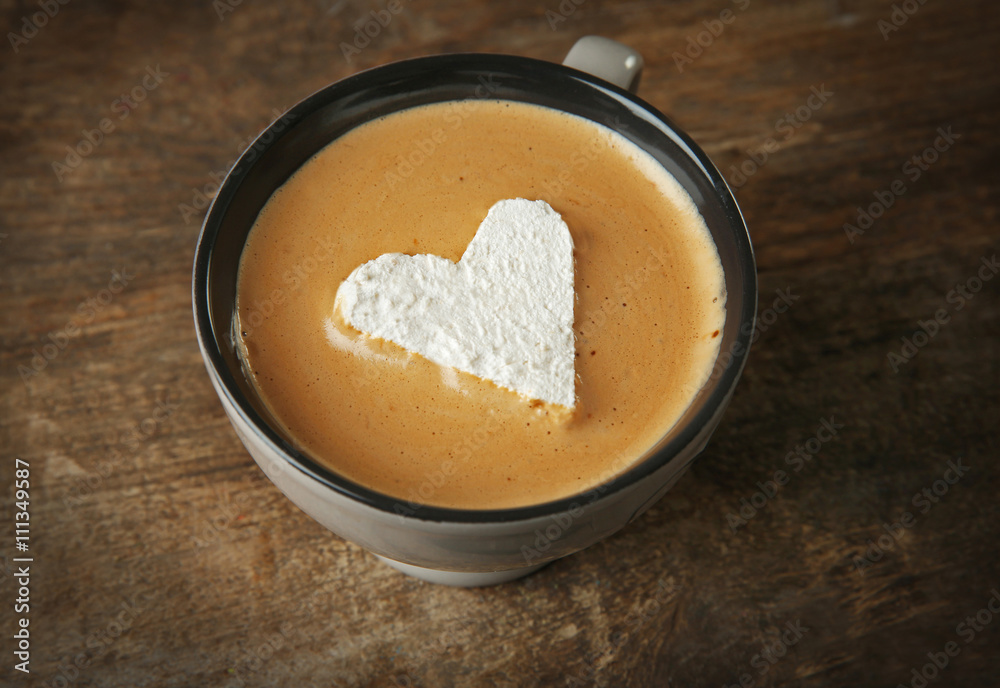 Cup of coffee with marshmallow on wooden table Cup of coffee with marshmallow on wooden table