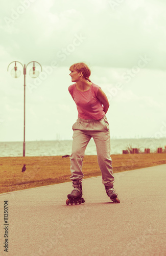 Girl skating alone on seafront.
