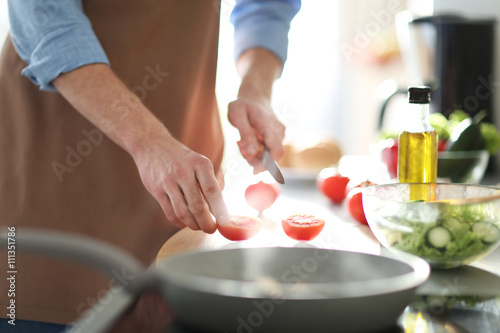 Man cooking dinner in kitchen