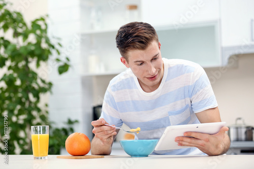 Handsome man with tablet an...