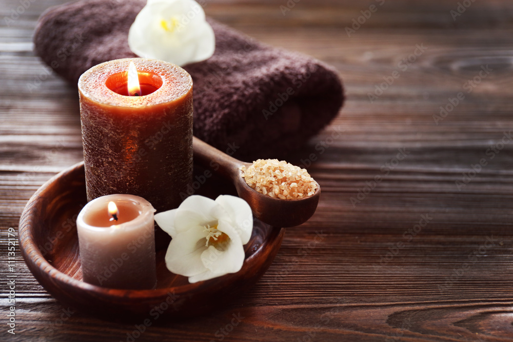 Spa composition with alight candles and beautiful flowers on wooden background Spa composition with alight candles and beautiful flowers on wooden background