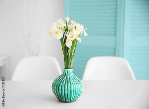 Fresh white irises on dinning table, indoors