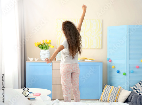 Girl stretching after wake up