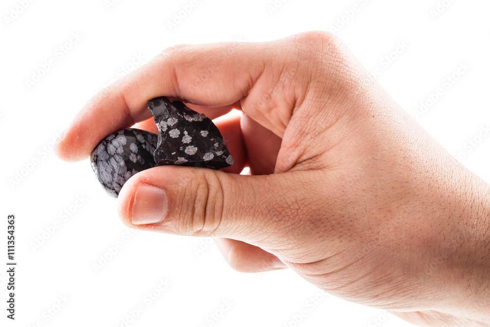 Holding two obsidian stones Holding two obsidian stones