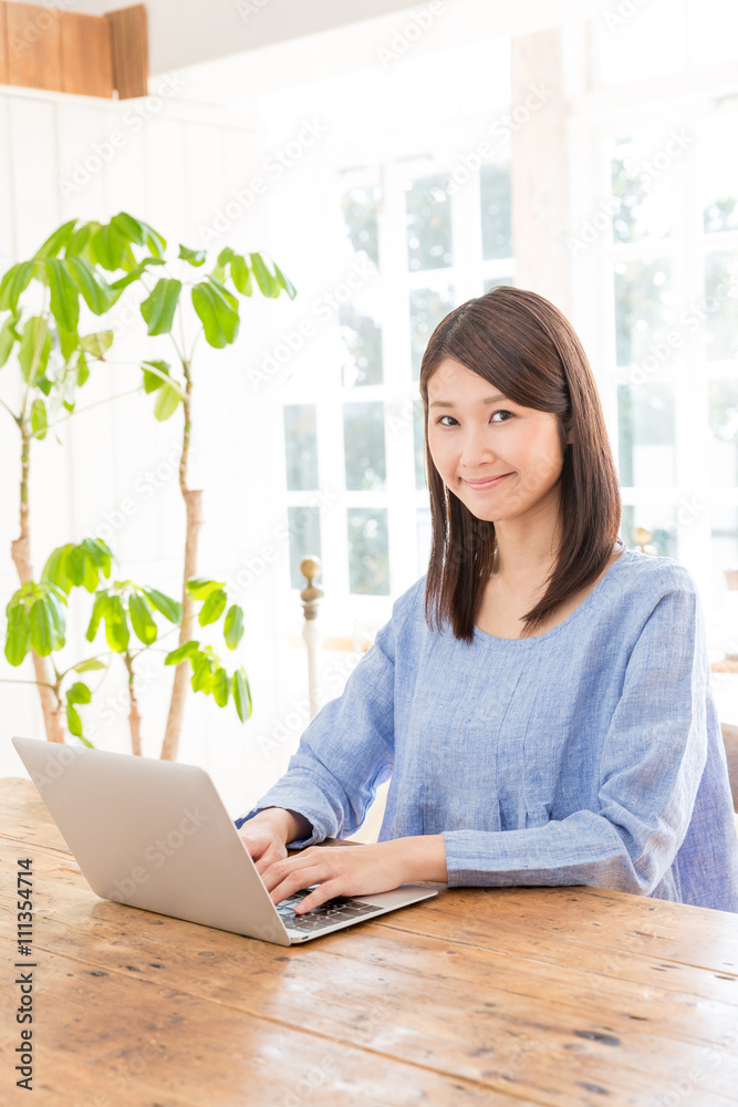 young asian woman using laptop