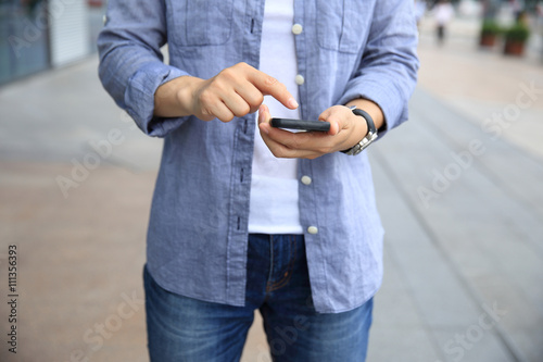 woman hands with smart phone in modern city