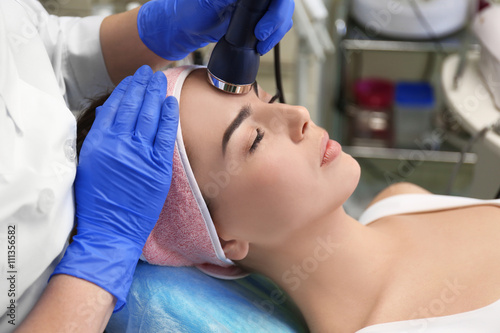 Young woman having face pro...