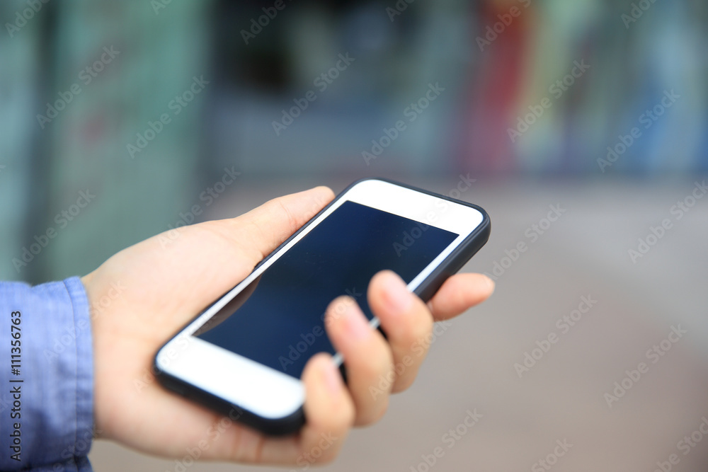 woman hand with smart phone in modern city