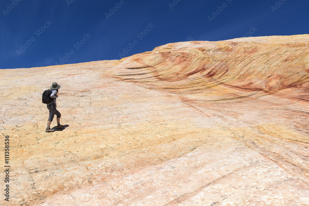 Female Hiker on Yellow Rock - Multicolored sandstone rock in Grand Staircase-Escalante National Monument, Utah