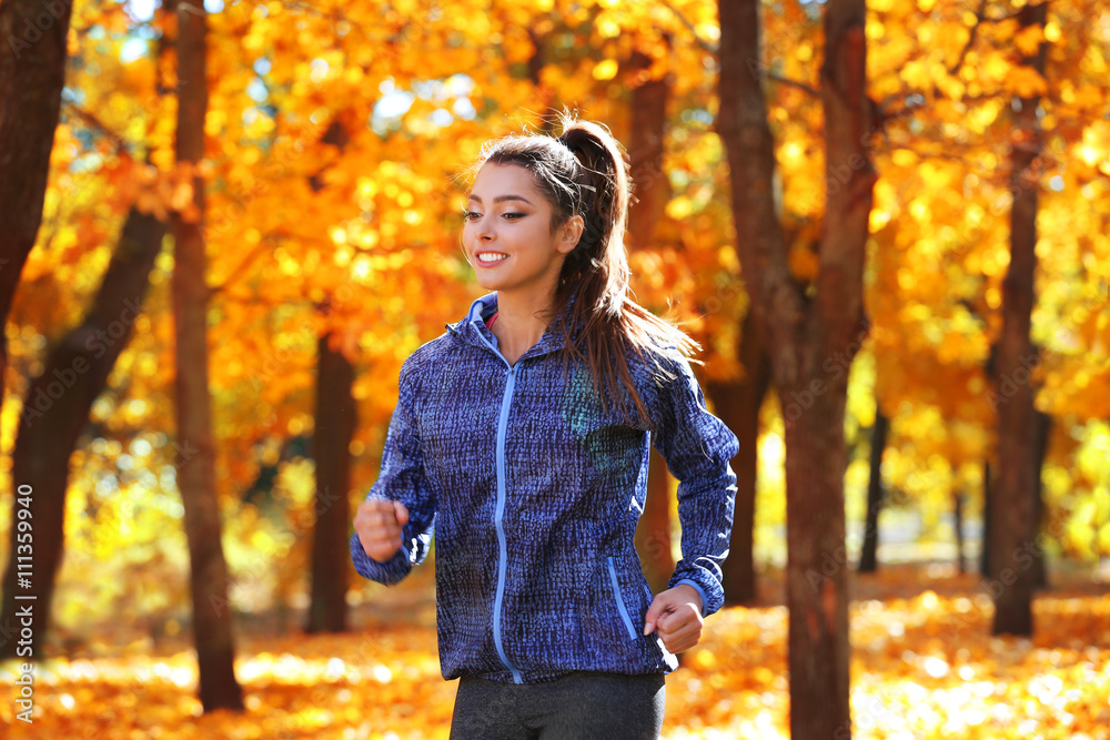 Young beautiful woman jogging in autumn park Young beautiful woman jogging in autumn park