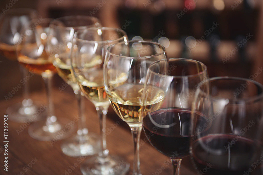 Many glasses of different wine in a row on bar counter Many glasses of different wine in a row on bar counter