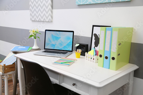 Stylish workplace with lapt...