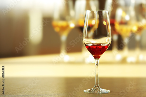 Glass of red wine on a table, close up