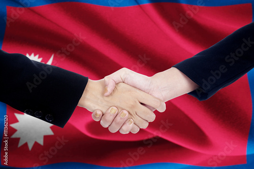 Partnership handshake with flag of Nepal