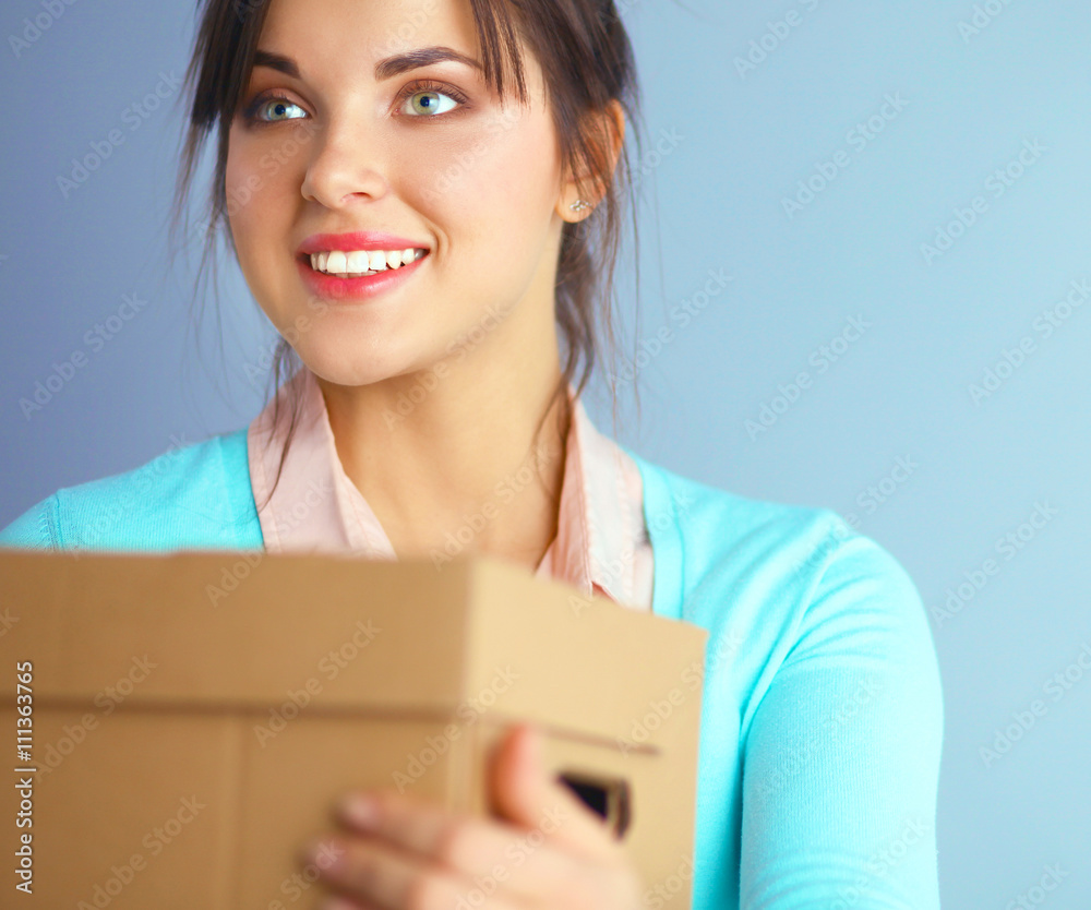 Portrait of pretty woman holding a box 