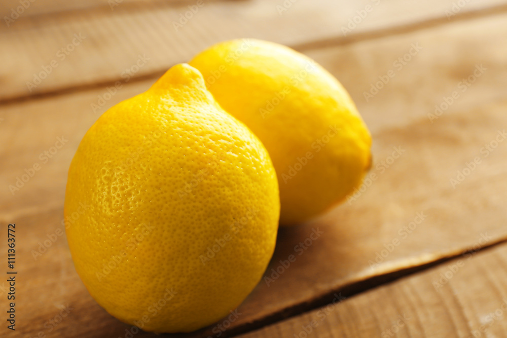 Fresh lemons on wooden background