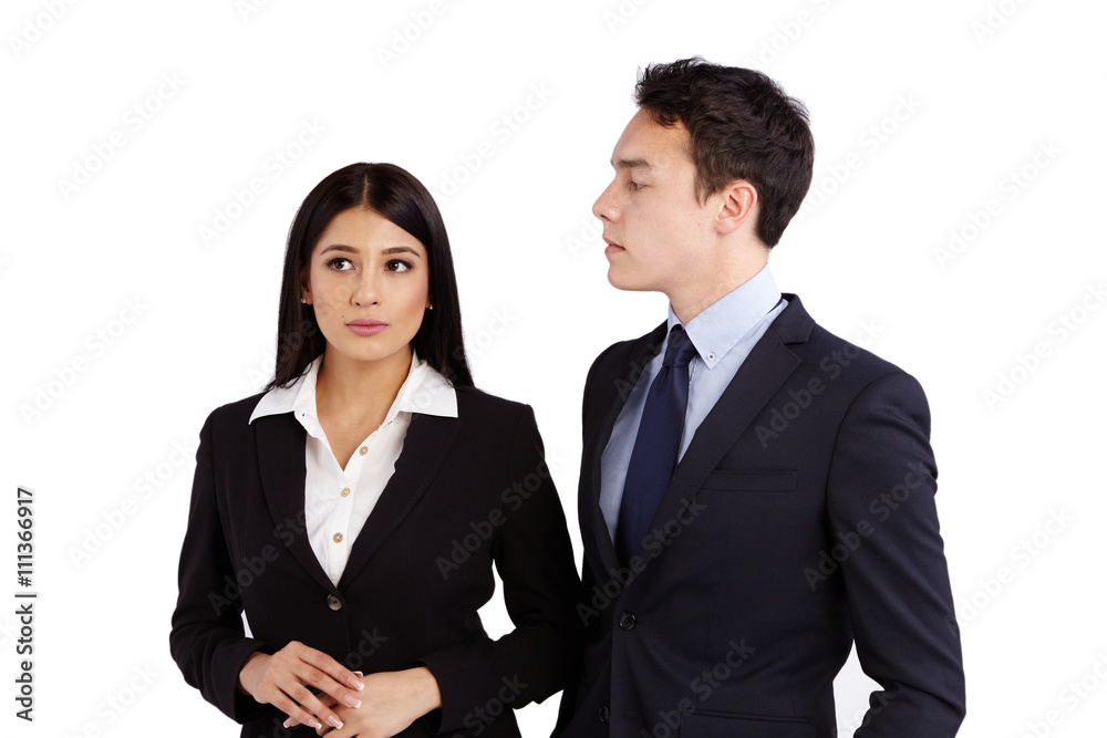 Young business man looking at a business woman disapprovingly Young business man looking at a business woman disapprovingly