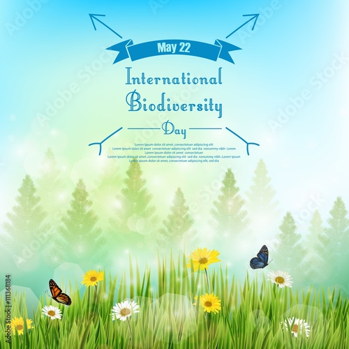 Biodiversity background with palm tree and flowers in grass on blue sky background