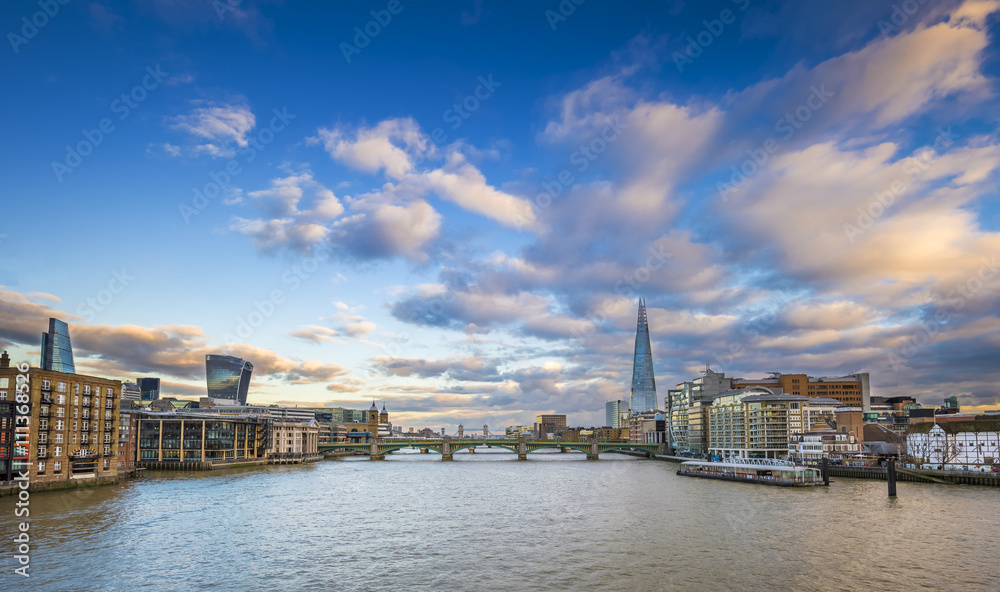 London skyline at sunset from Millennium Bridge with Tower Bridge, Shard and other famous landmarks - London, UK