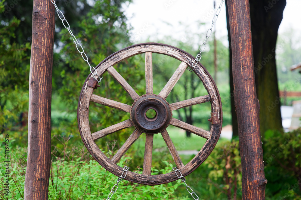 old wooden wheel from a cart in village