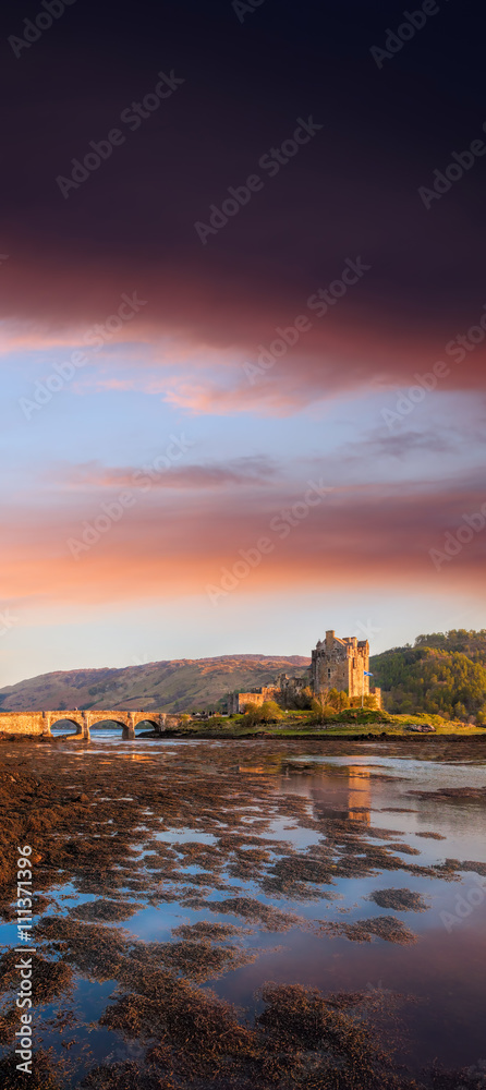 Eilean Donan Castle against sunset in Highlands of Scotland