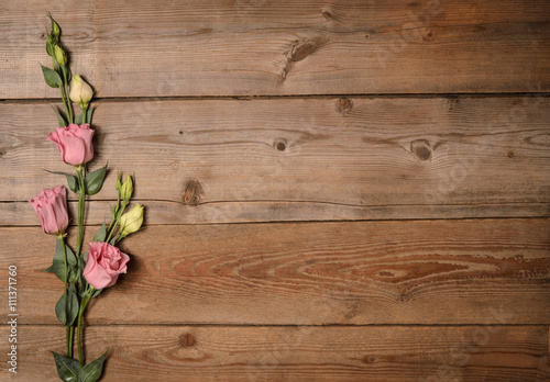 Beautiful eustoma on wooden background