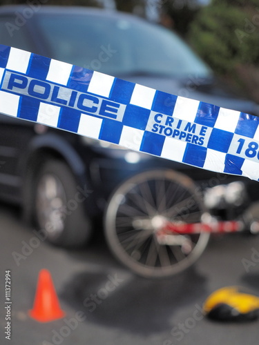 Blue and white Police tape used to cordon off a damaged bicyle under a car like a crime scene, Australia 2016
