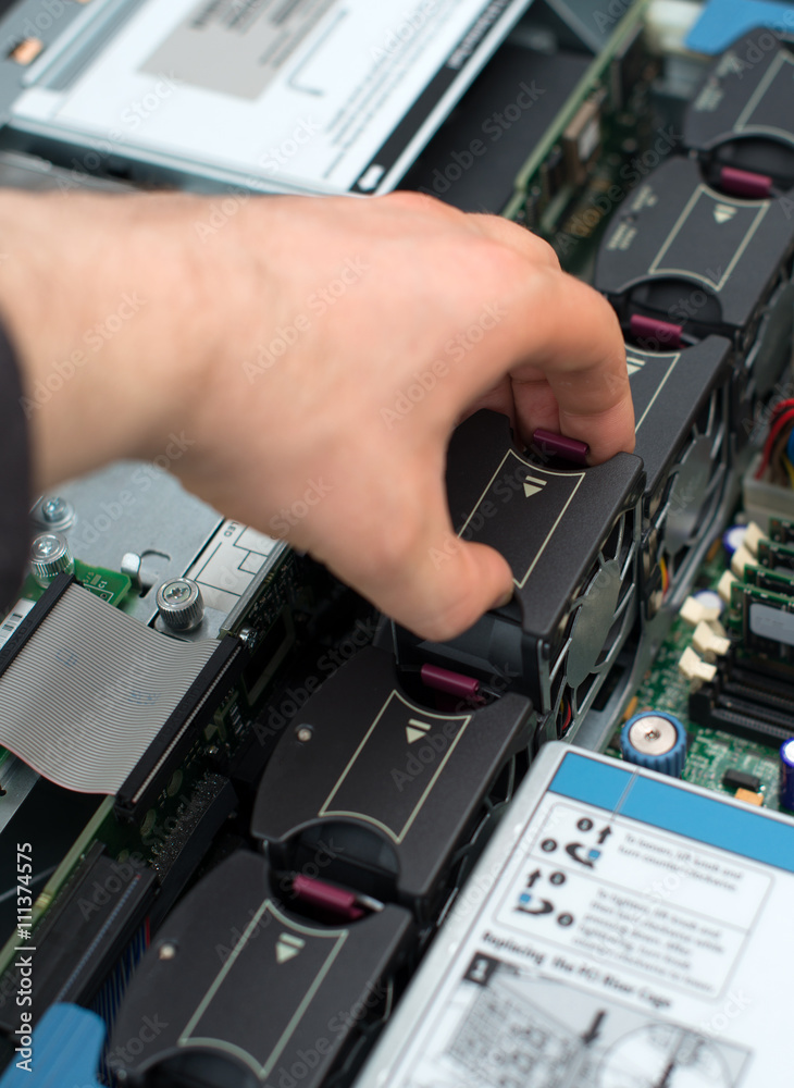 Computer technician installing cooler fan into motherboard. Computer technician installing cooler fan into motherboard.