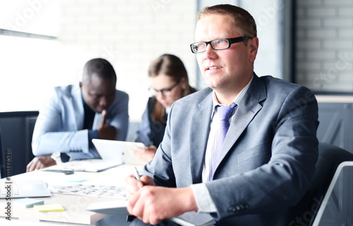 Businessman with colleagues in the background