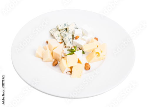 Assorted cheese platter with almonds and mint.