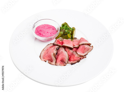 Sliced roast beef with pickles.