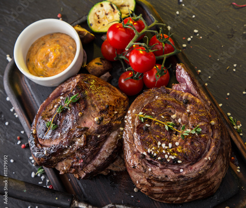 Delicious beef steak on black stone table. photo