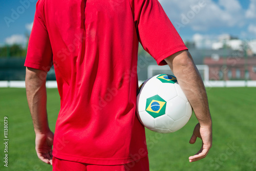 Brazilian soccer player, holding a soccer ball