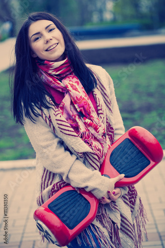 Young white girl with electric mini hover board scooter photo