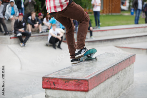 Skater grinding on a ledge in skatepark