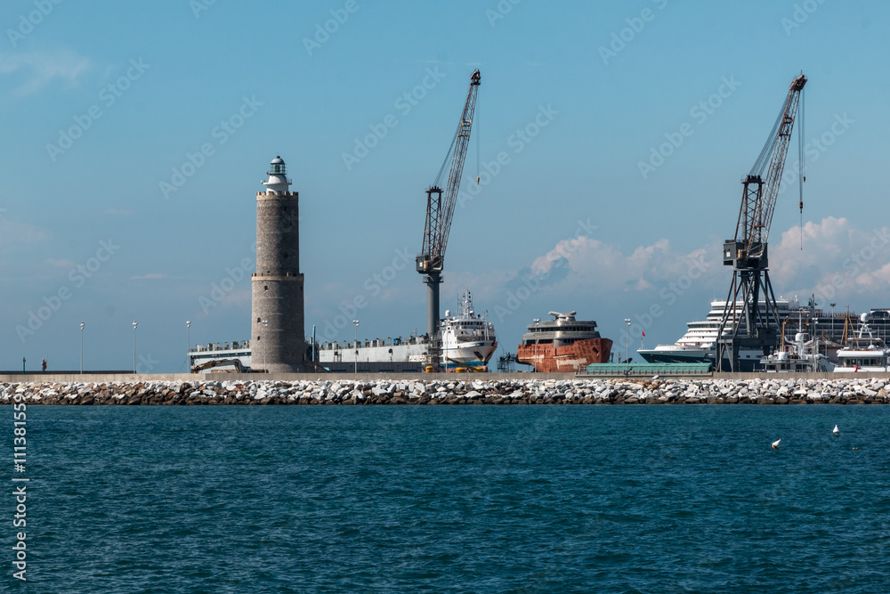 Cranes at Work in Boatyard near Lighthouse