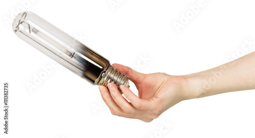 Energy-efficient sodium lamp in  female hand isolated on white. photo