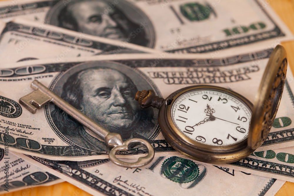 Time and money concept image - old silver pocket watch and US cu Time and money concept image - old silver pocket watch and US cu