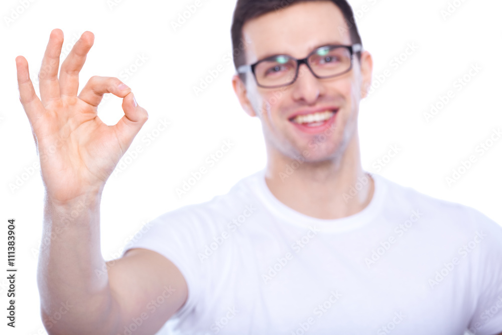 Well done. A young man in glasses showing ok. White background. Well done. A young man in glasses showing ok. White background.
