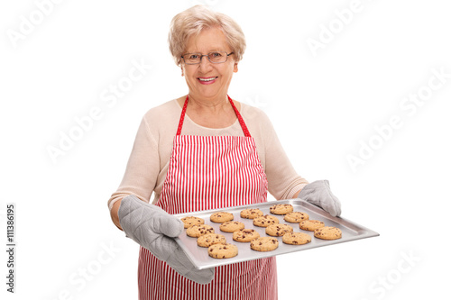 Mature lady holding a tray with cookies
