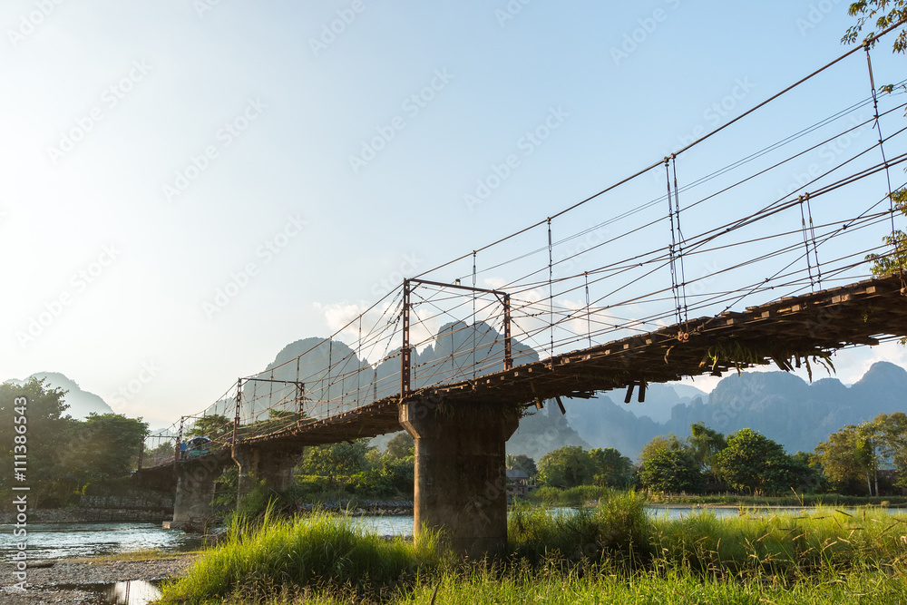 Bamboo bridge over Nam Song River at Vang Vieng village, Laos Bamboo bridge over Nam Song River at Vang Vieng village, Laos