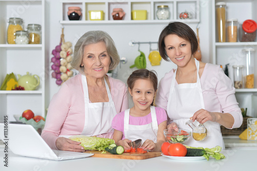 women with little girl cooking