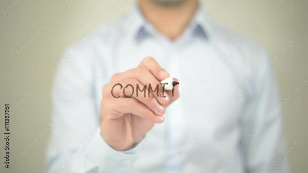 Commitment, Man writing on transparent screen Commitment, Man writing on transparent screen